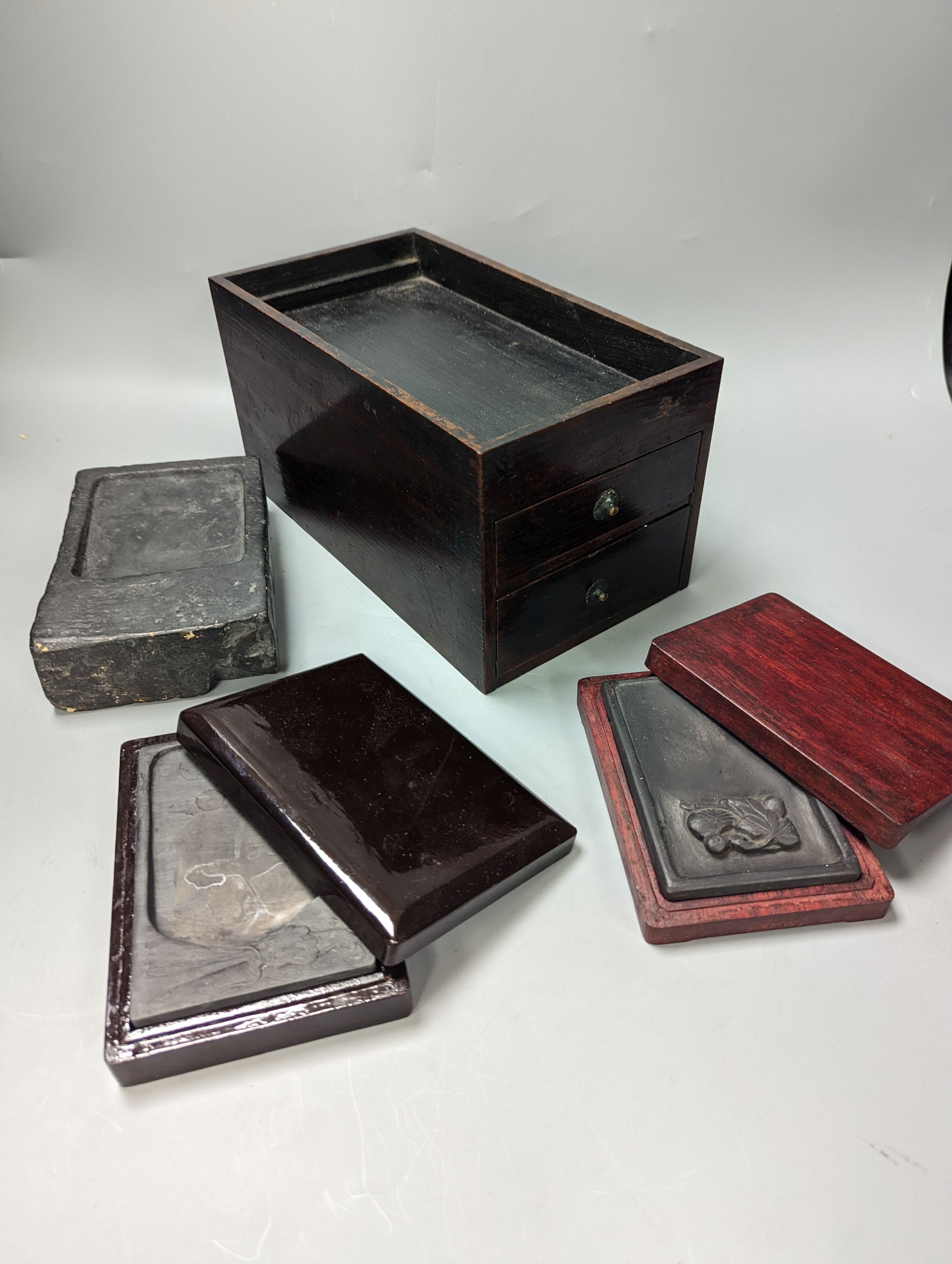 Three Chinese ink-stones, two in fitted boxes and a Japanese writing box, box 26 cms deep 14-5 wide.